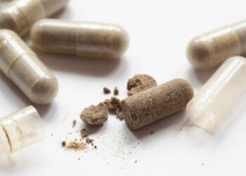 Drug capsules are laid on a table.