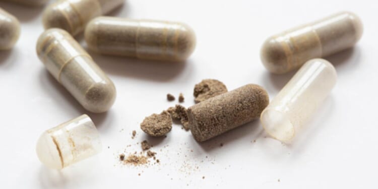 Drug capsules are laid on a table.
