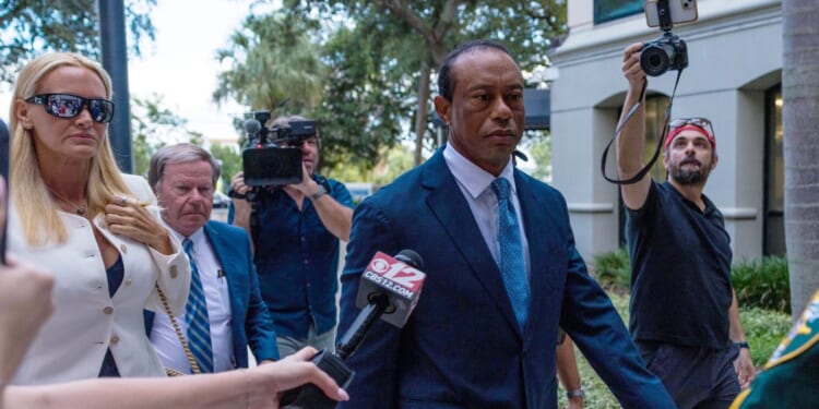 Tiger Woods, accompanied by Vanessa Trump, left, attends a hearing at Martin County Courthouse Wednesday in Stuart, Florida, in connection with a crash that occurred on Jupiter Island in March.