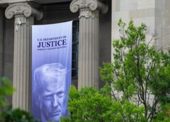 The Department of Justice building in Washington, D.C. is displayed with President Trump’s banner hanging on the pillars on June 23, 2026.