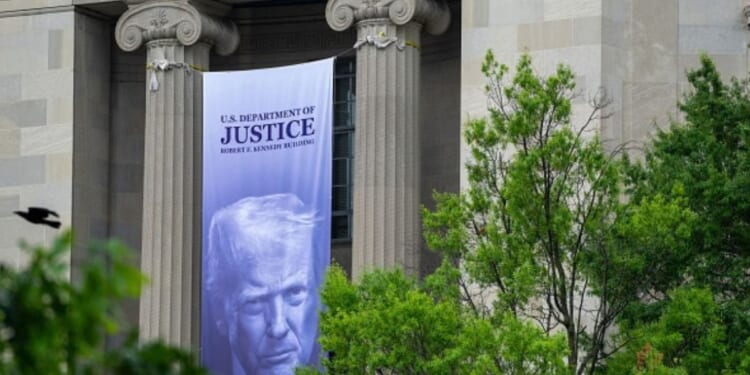The Department of Justice building in Washington, D.C. is displayed with President Trump’s banner hanging on the pillars on June 23, 2026.