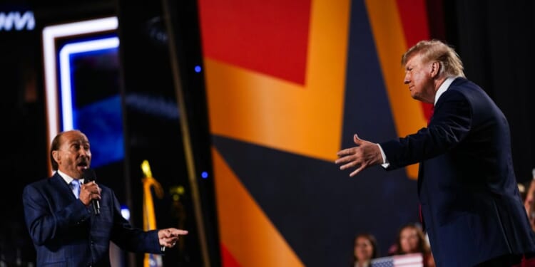 Musician Lee Greenwood greets President Donald Trump as he takes the stage to speak on the second day of the 2026 Republican National Convention at the American Airlines Center on Sept. 10, 2026, in Dallas, Texas.