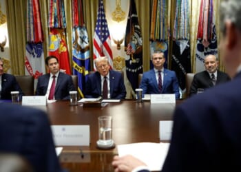 Trump cabinet officials sit on the cabinet room alongside President Trump on August 26, 2025 in the White House.