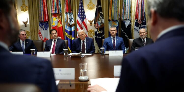 Trump cabinet officials sit on the cabinet room alongside President Trump on August 26, 2025 in the White House.