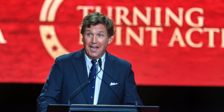 Political commentator Tucker Carlson speaks during the memorial service for political activist Charlie Kirk at State Farm Stadium on Sept. 21, 2025, in Glendale, Arizona.
