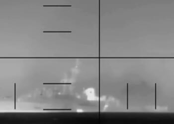 A camera shot of an Iranian frigate, the IRIS Dena, sinking while in flames on March 4, 2026.