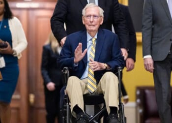 Kentucky Senator Mitch McConnell waves to a crowd in the United States Capitol as he is wheeled in on September 14, 2026.