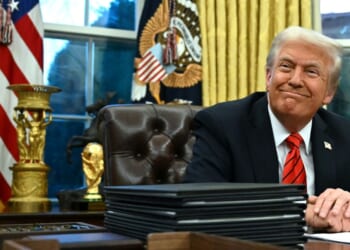 President Donald Trump smiles after signing an executive order in the Oval Office of the White House in Washington, D.C., on Feb. 10, 2025.