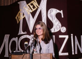 Feminist author Gloria Steinem speaks from a podium at a 1985 news conference about Ms magazine, which she cofounded.