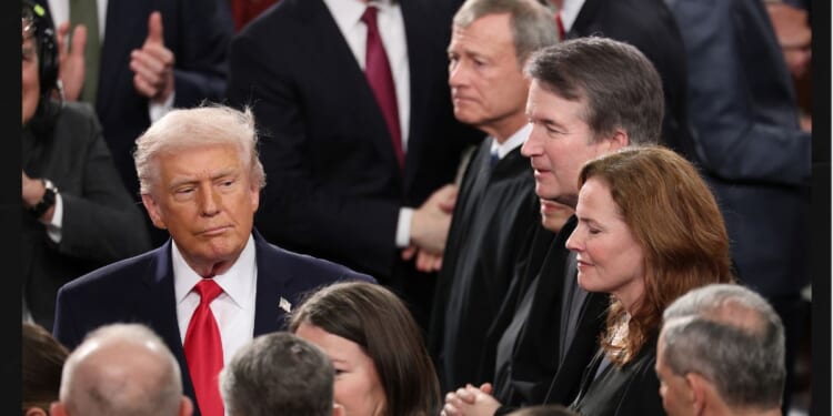 President Donald Trump walks past Supreme Court Chief Justice John Roberts, Associate Justice Elena Kagan, Associate Justice Brett Kavanaugh and Associate Justice Amy Coney Barrett on Feb. 24 as he arrives for the State of the Union address during a joint session of Congress at the U.S. Capitol in Washington, D.C.