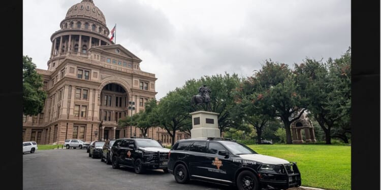 Texas Department of Public Safety vehicles sit parked outside of the Texas State Capitol in Austin, Texas Thursday. Officials announced that they received information about a planned attack on the Capitol.
